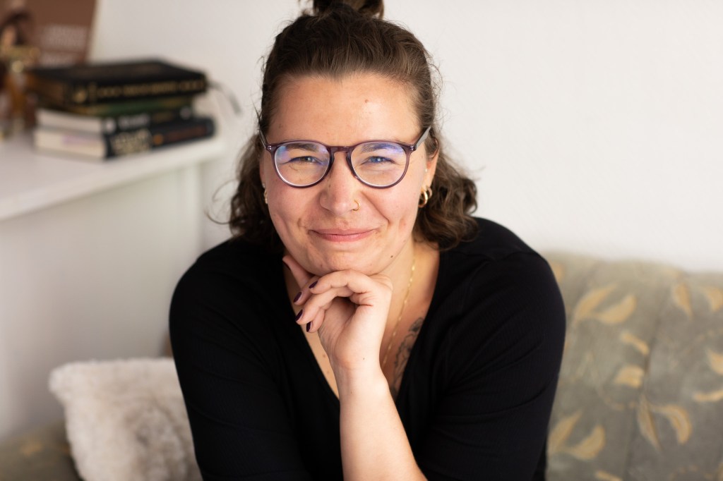 Jule looks at the camera, grinning. 